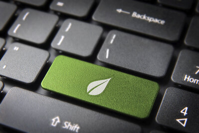 Green leaf keyboard key, environment background Niort Agglo signe une charte numérique responsable