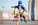 Portrait of preteen boy, inline skater in protective gear, practicing forward slalom at outdoor skate park